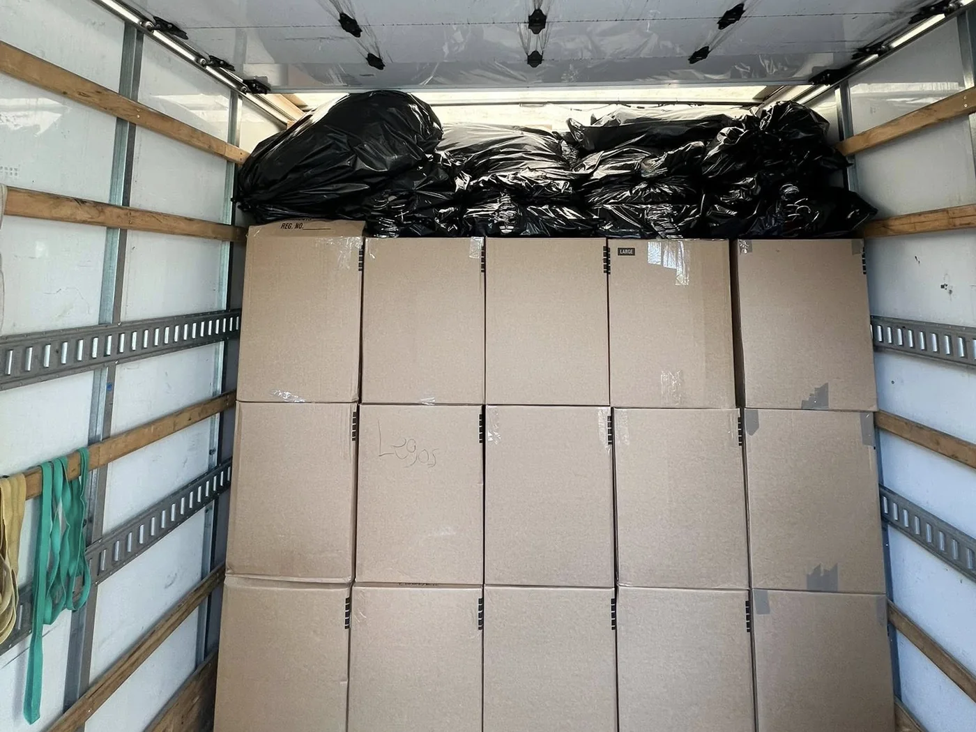 Boxes stacked in rows inside a moving truck
