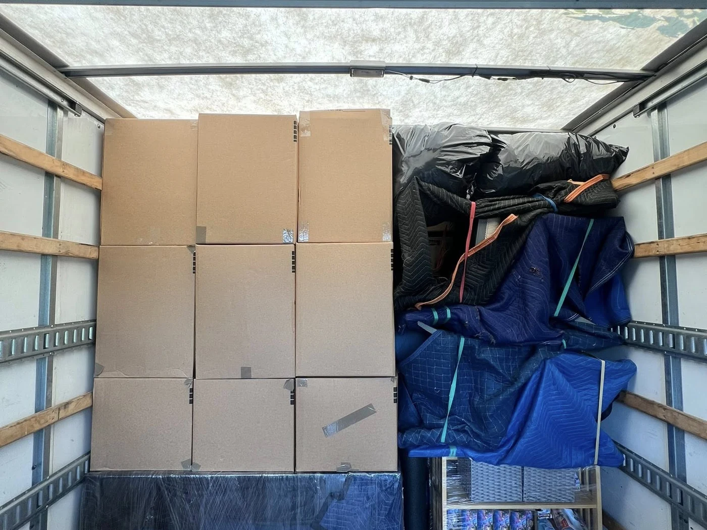 Boxes and household contents organized inside a moving truck