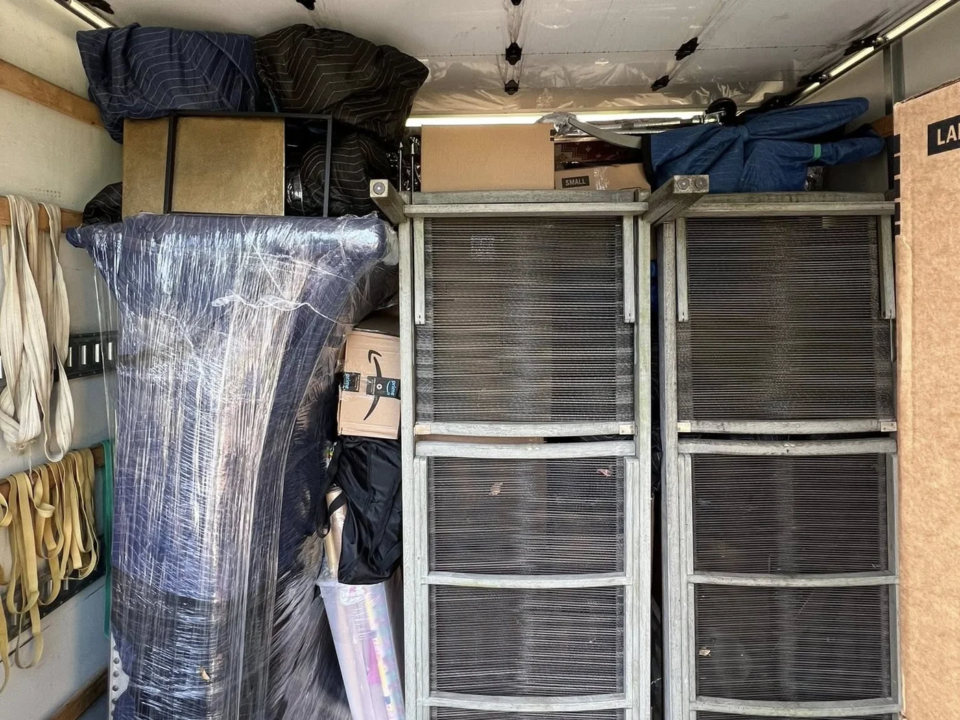 Protected business furniture and equipment organized inside a Hands On Deck moving truck