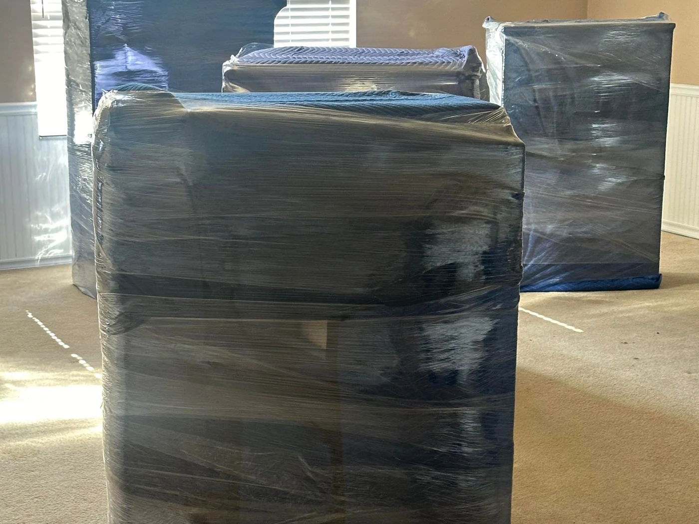 Furniture protected with moving wrap before handling