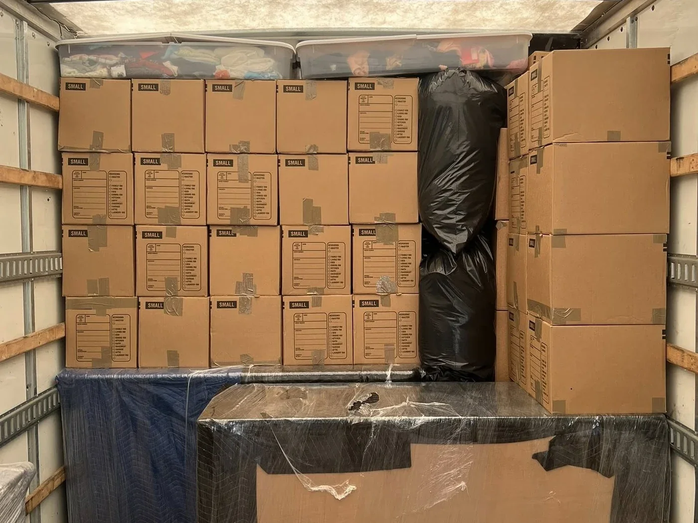 Organized moving truck loaded with protected furniture and boxes
