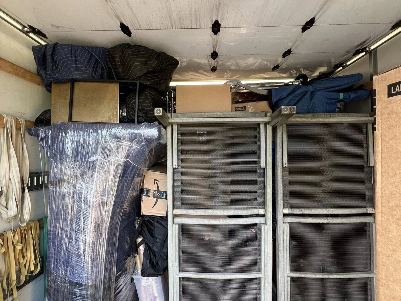 Organized furniture and equipment loaded inside a Hands On Deck moving truck