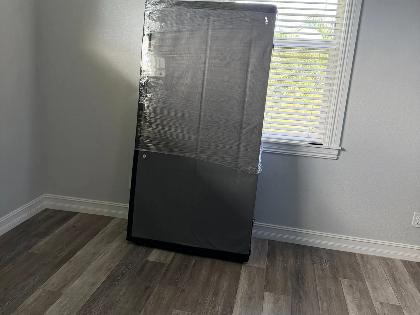 Large item protected with moving wrap before transport