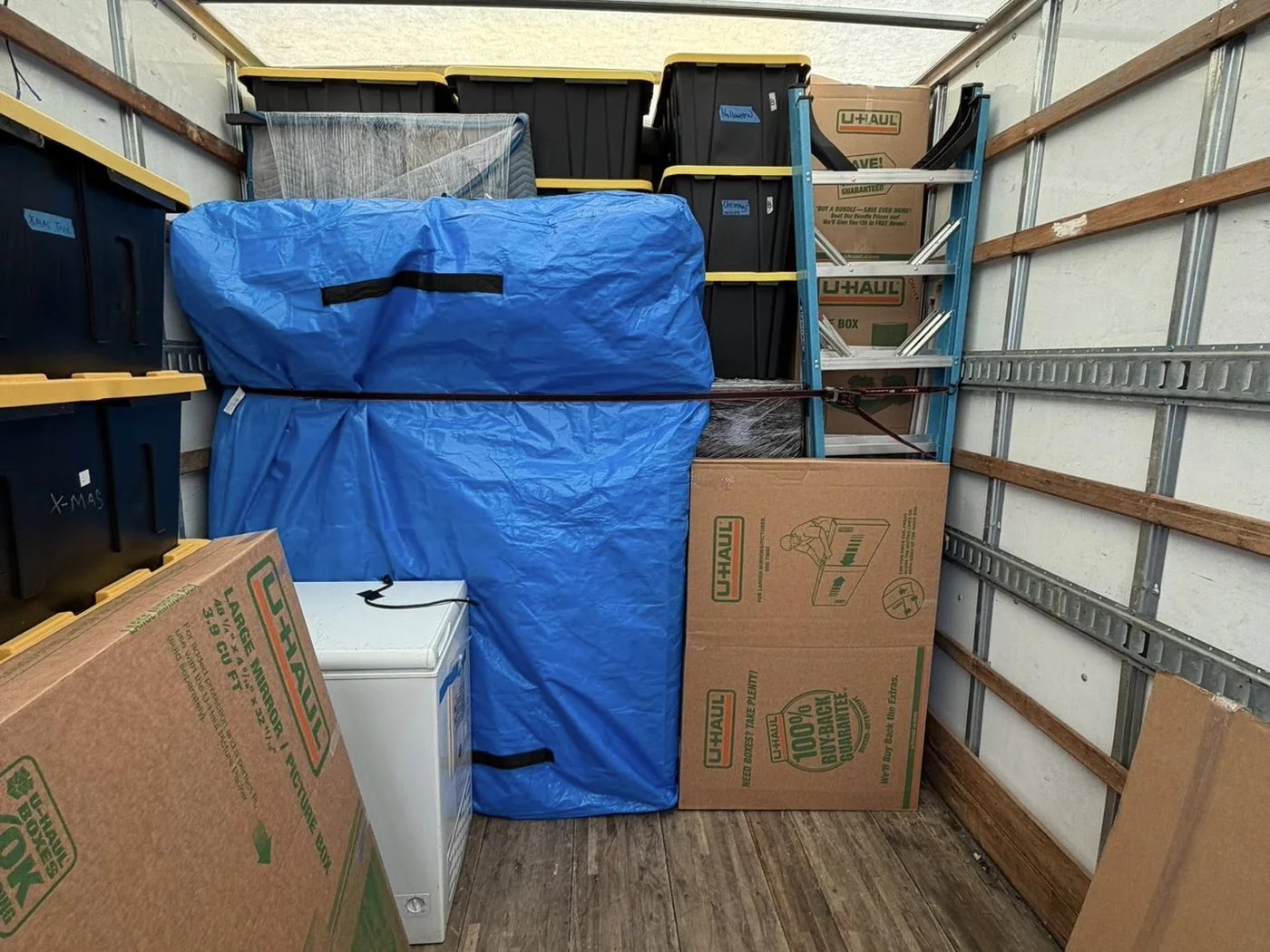 Organized moving truck load with protected household contents and boxes