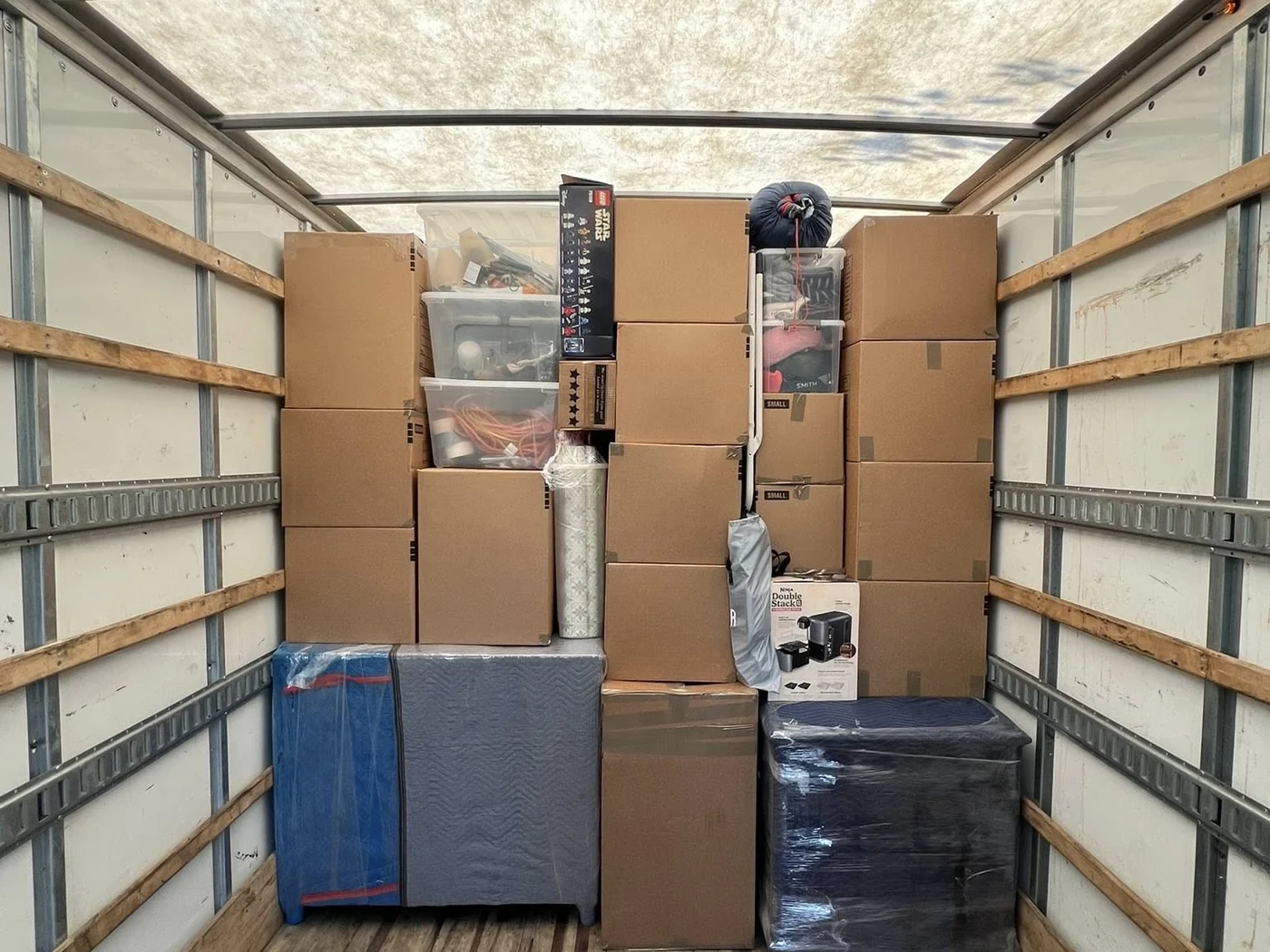 Household boxes and protected furniture loaded inside a moving truck