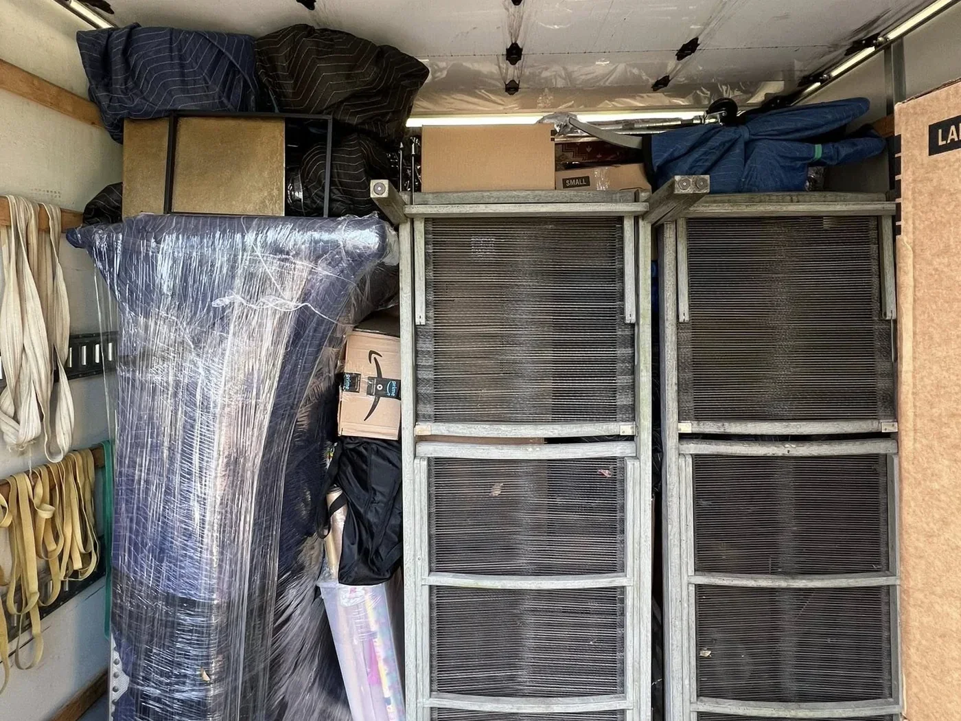 Moving truck loaded with wrapped furniture and business items