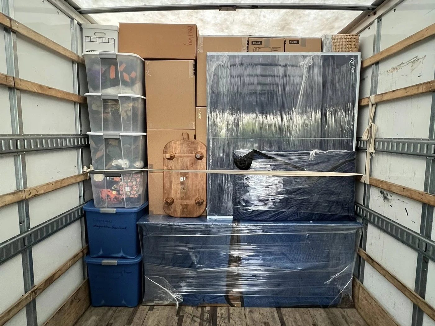 Boxes and protected household items organized inside a moving truck