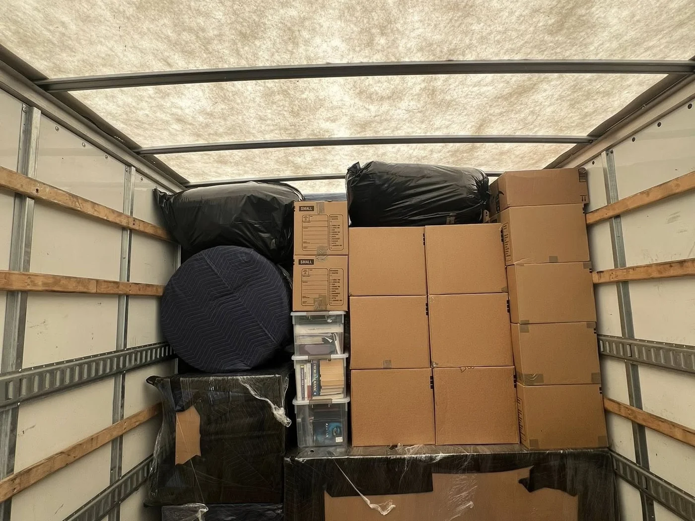 Organized Hands On Deck moving truck load with boxes and protected furniture